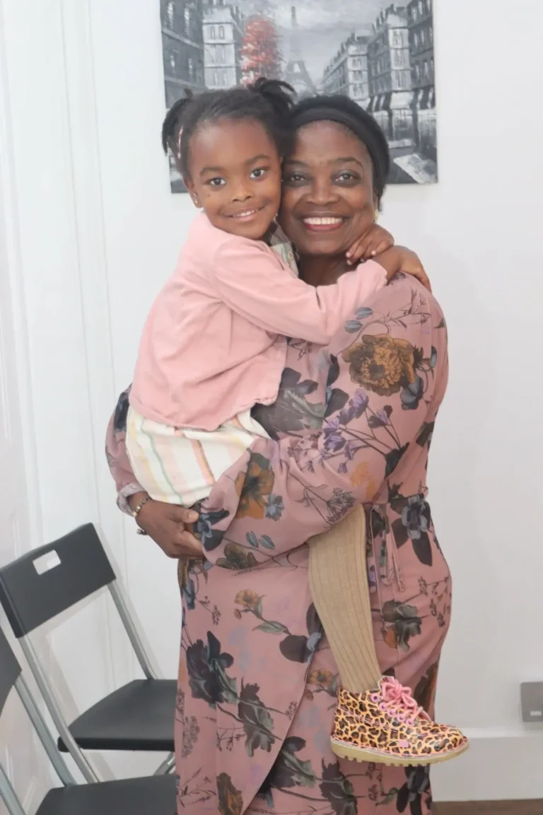 A joyful mother and daughter sharing a warm embrace in a bright room.