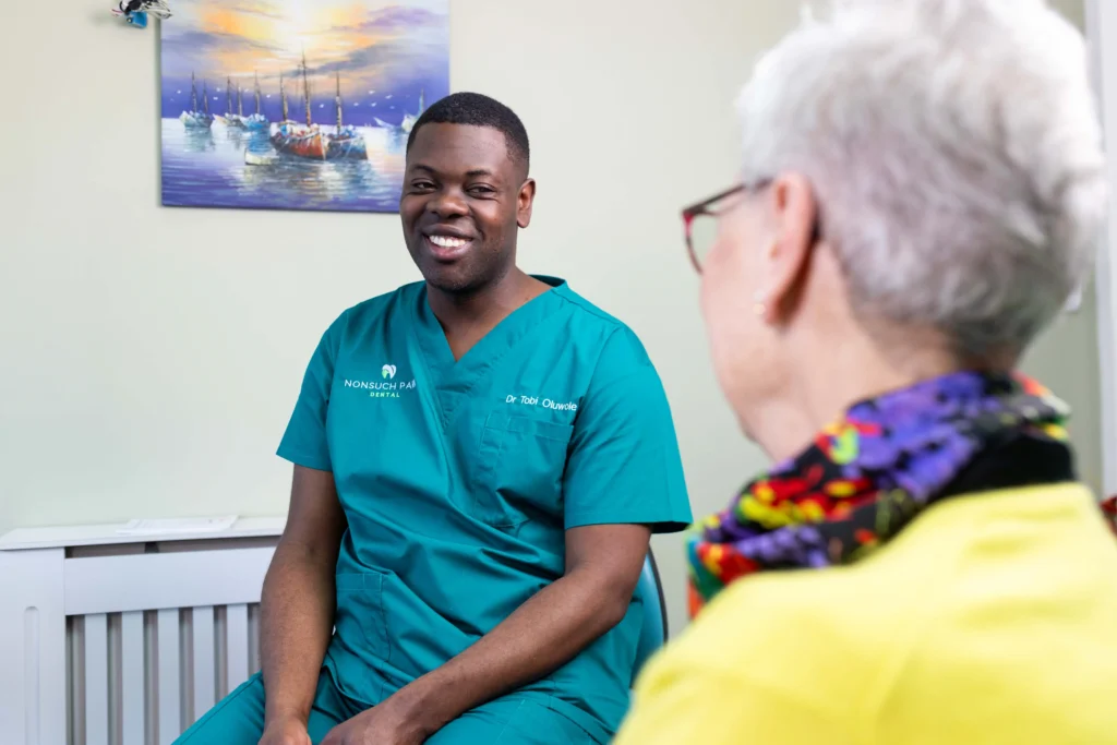 Dentist engaging with a patient, showcasing a caring dental environment.